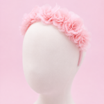 Baby pink floral hairband for girls featuring soft layered chiffon flowers on a comfortable fabric-covered headband, displayed on a white mannequin against a pastel pink background."