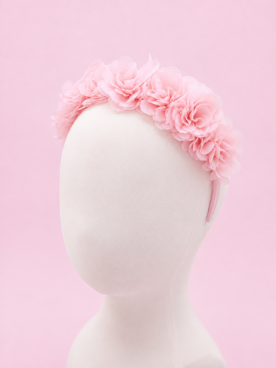 Baby Pink Floral Hairband for Girls | Soft organza Flower Headband Baby pink floral hairband for girls featuring soft layered chiffon flowers on a comfortable fabric-covered headband, displayed on a white mannequin against a pastel pink background."